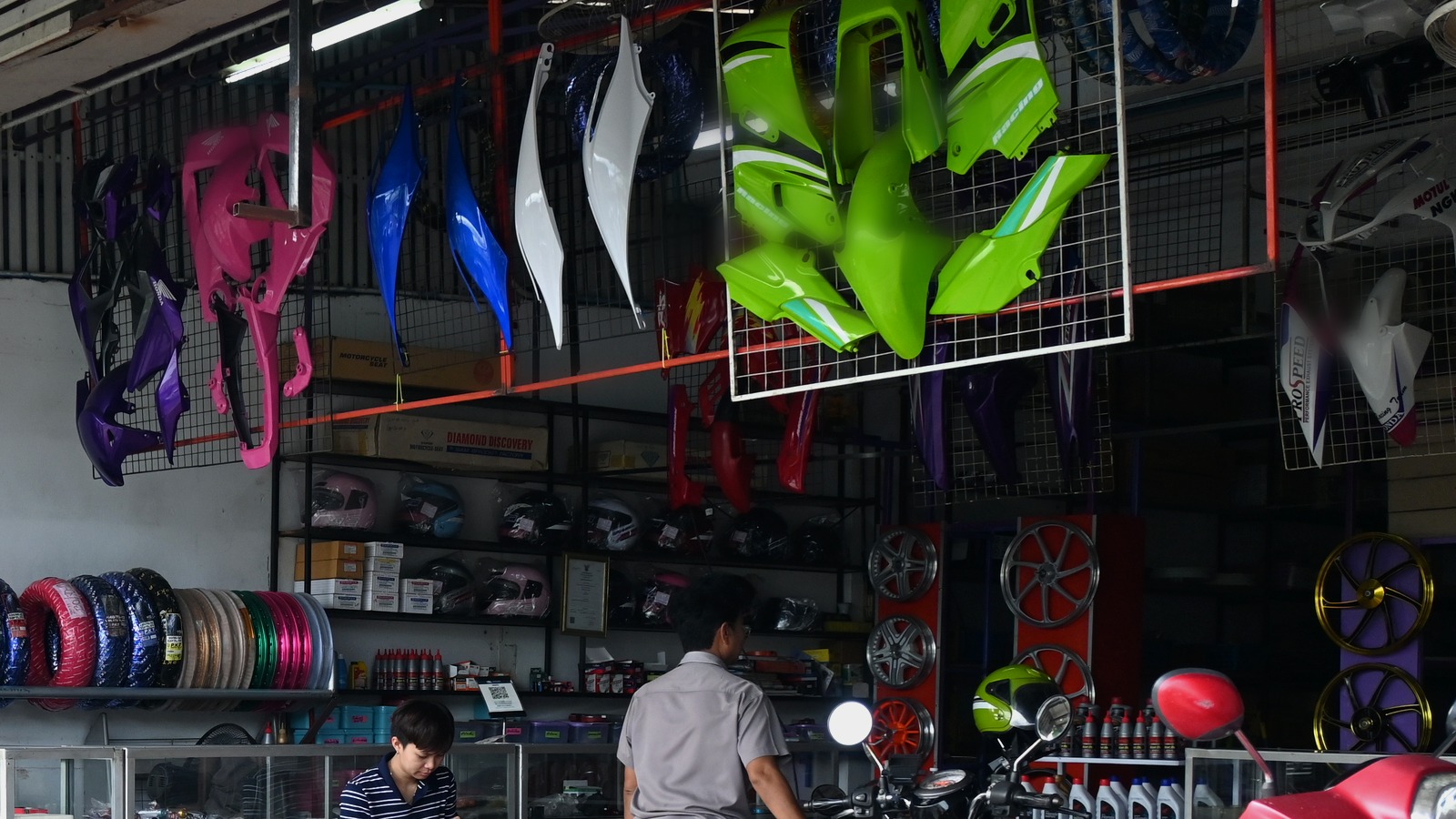 Balcão de peças e motos em oficina especializada, representando controle de serviços, estoque e atendimento em oficina de motos
